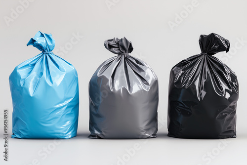 Three garbage bags in different colors on white background photo