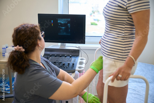 Woman doctor uses a modern ultrasound machine photo