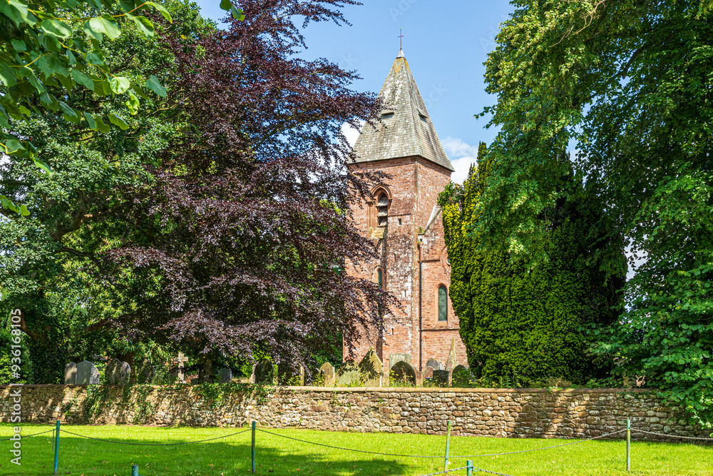 The Victorian church of St. Mary (opened in 1870) built of the local Old Red Sandstone in the village of Walton, Cumbria, England UK