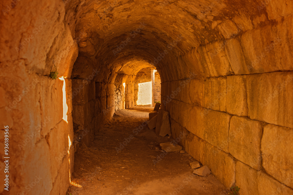 Fototapeta premium Greece, wall and tunnel in ruins for architecture, archeology and travel to ancient city. History, rock and path in abandoned Greek theater for exploration, culture and anthropology in Miletus