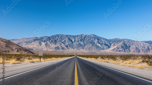 Empty road leading to mountains in death valley national park