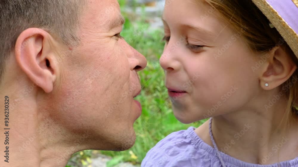 Dad kisses his daughter. Picnic in nature. Dad kisses his daughter. Picnic in nature.