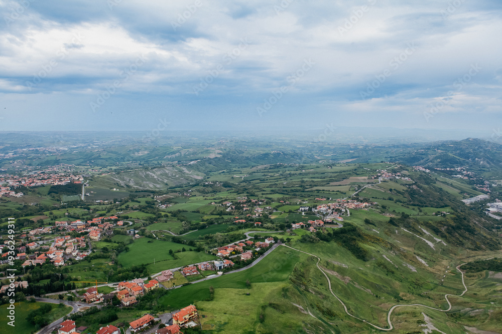Fototapeta premium Vast green hills and valleys of San Marino under a cloudy sky