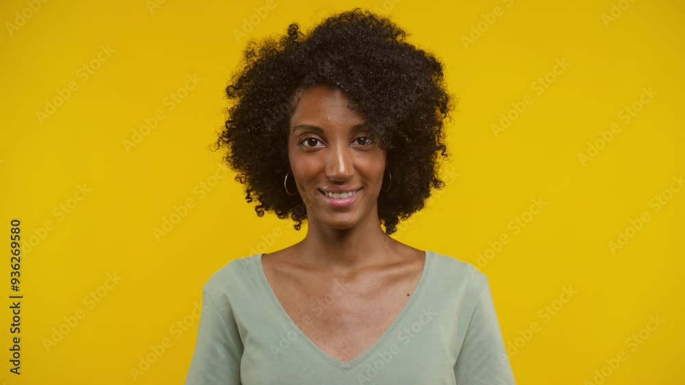 Woman Nodding Head in Approval Gesture on Yellow Background Woman Nodding Head in Approval Gesture on Yellow Background