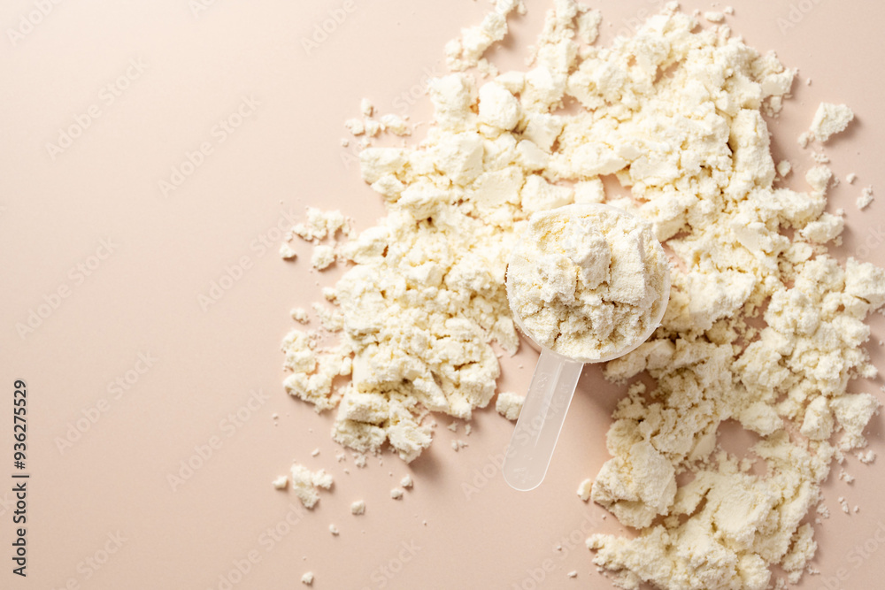 Protein powder. Vanilla flavour of protein powder in a scoop, closeup. Protein powder. Vanilla flavour of protein powder in a scoop, closeup.