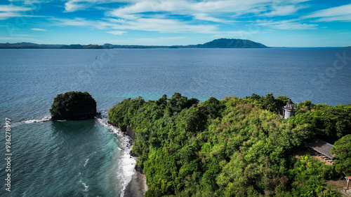 Aerial view of Nosy Tanikely island in Madagascar showcasing lush greenery and vibrant blue waters on a sunny day photo