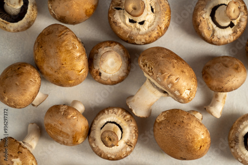 Raw champignons on bright background, button mushrooms. Vegan protein.  photo