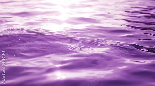 A close-up of a purple water surface with light reflecting off the water.