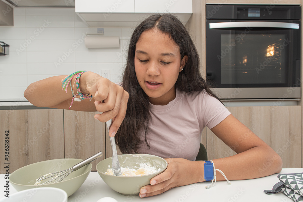 Poster Print Focused girl mixing cookie dough in a bowl in modern kitchen 40x26.7 cm