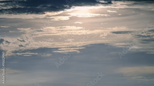 A mesmerizing sky is revealed after a passing rain shower. Soft, wispy clouds dance across a canvas of blue, illuminated by the warm sunlight. DaJian Mountain, New Taipei City, Taiwan. photo