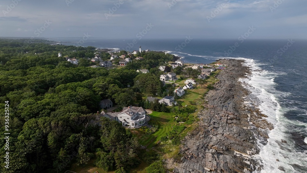 Fototapeta premium Living beside the Ocean along the rocky coastline in Maine as waves break on beach in summertime