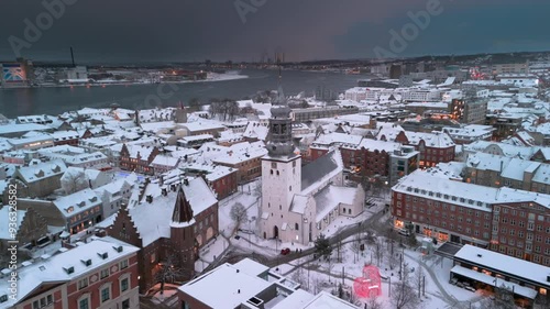 Aerial winter skyline panoramic view of Aalborg covered with snow. Old town with the Budolfi Church (Budolfi Kirke). North Jutland, Denmark  photo