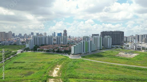 Aerial of Camko city project in Phnom Penh suburbs, Green agricultural field and urban construction photo