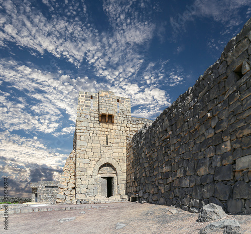 Ruins of Azraq Castle (Qasr al-Azraq) is a crusader castle (300AD), central-eastern Jordan, 100 km east of Amman, Jordan. Against the background of a beautiful sky with clouds