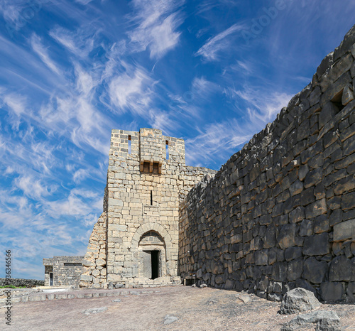 Ruins of Azraq Castle (Qasr al-Azraq) is a crusader castle (300AD), central-eastern Jordan, 100 km east of Amman, Jordan. Against the background of a beautiful sky with clouds