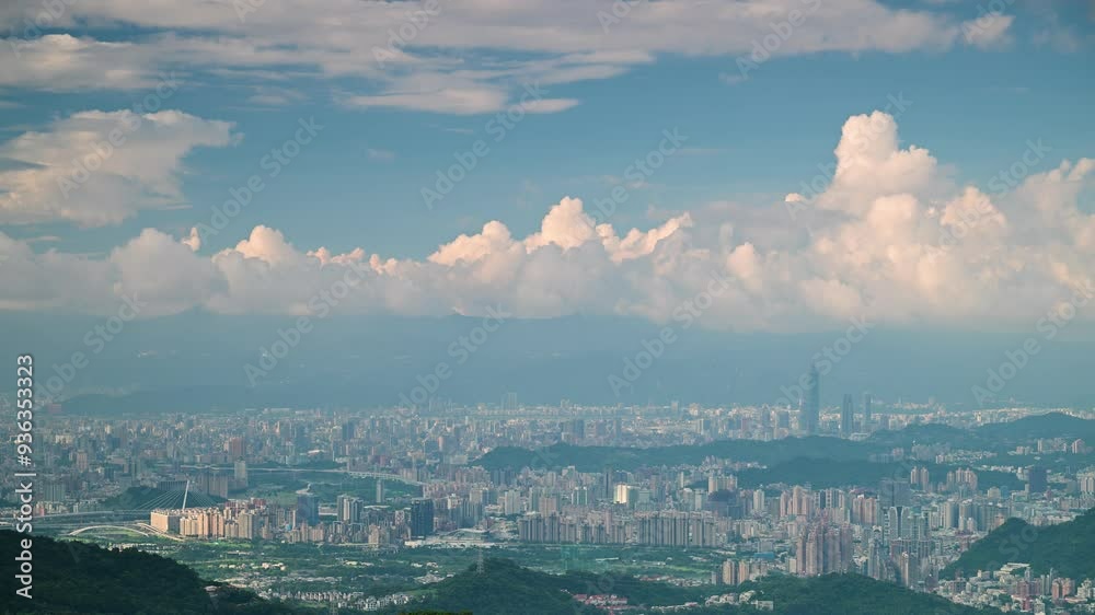 A serene aerial view of Taipei City on a sunny afternoon. A massive, billowing cloud casts a shadow over the urban landscape, creating a dramatic contrast against the clear blue sky. Taiwan. A serene aerial view of Taipei City on a sunny afternoon. A massive, billowing cloud casts a shadow over the urban landscape, creating a dramatic contrast against the clear blue sky. Taiwan.