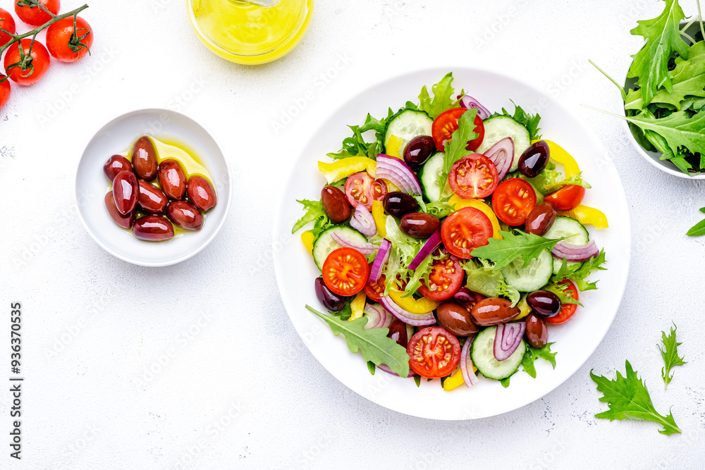Vegan vegetable salad with olives, tomato, paprika, cucumber and onion, healthy mediterranean food. White background, top view Vegan vegetable salad with olives, tomato, paprika, cucumber and onion, healthy mediterranean food. White background, top view