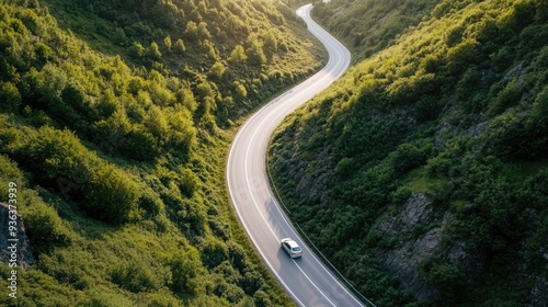 Aerial view of a car driving through a valley during a summer road trip