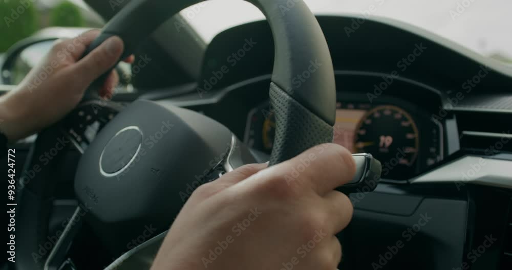 A man drives a car. Close-up of his hands, an unrecognizable person. View from the car interior. Summer day A man drives a car. Close-up of his hands, an unrecognizable person. View from the car interior. Summer day