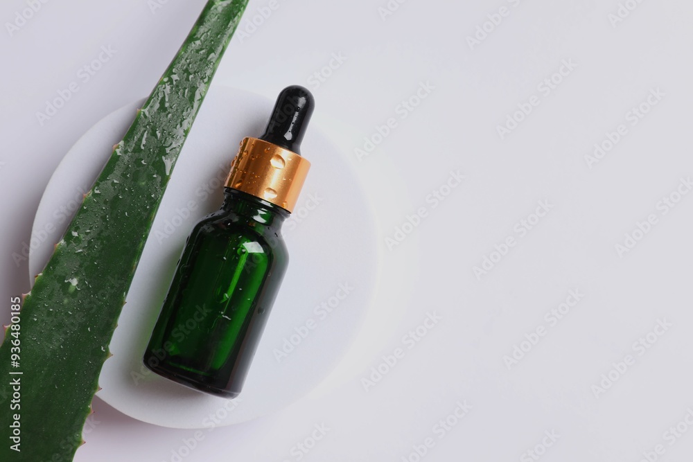 Skin care with cosmetic facial aloe serum. Glass bottle with a pipette on a white background. Dry skin care product. Essential oil for moisturizing the skin of the body.