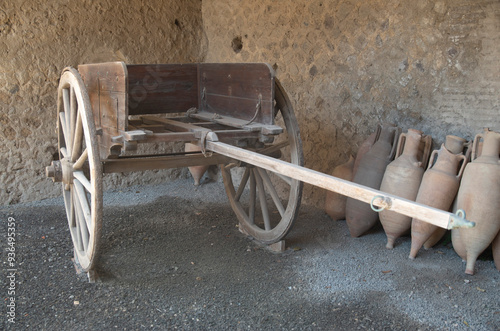 Copy of roman chariot and ancient amphorae from ruin of Pompeii in Italy