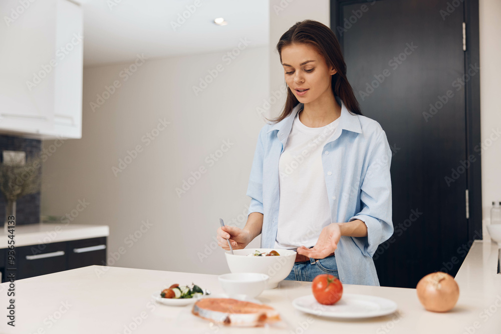 Woman preparing healthy meal in modern kitchen with bowl of food and plate of vegetables Woman preparing healthy meal in modern kitchen with bowl of food and plate of vegetables