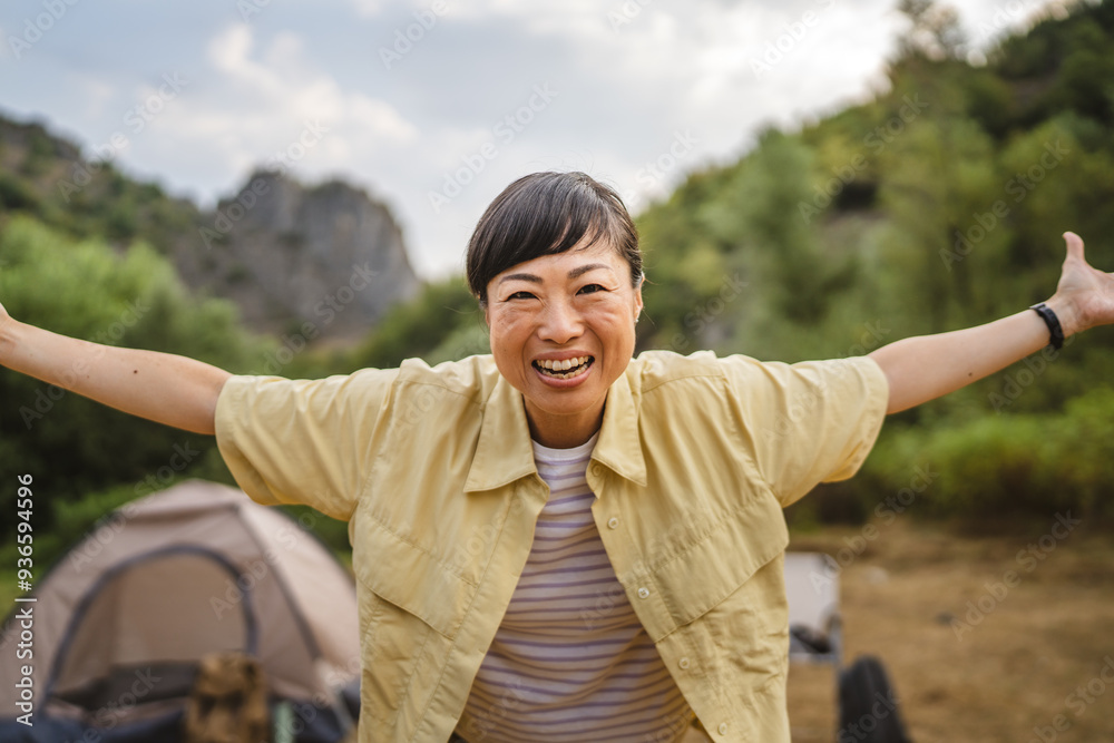 Portrait of mature japanese woman stand in front a tent in the forest Portrait of mature japanese woman stand in front a tent in the forest