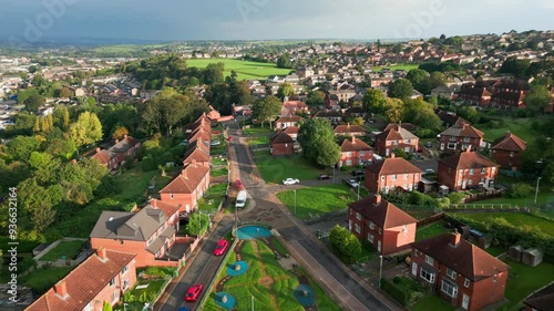 Yorkshire's residential district: Red brick council housing, aerial view, sunny morning, residents walking.