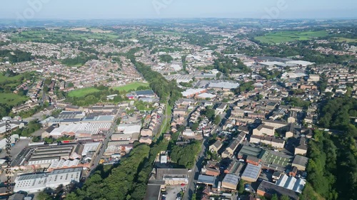 Heckmondwike, UK, captured by a drone, featuring industrial buildings, vibrant streets, the old town center, and the scenic Yorkshire view on a summer evening. photo