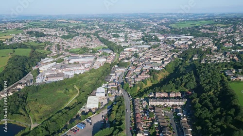 Heckmondwike, UK, captured by a drone, featuring industrial buildings, vibrant streets, the old town center, and the scenic Yorkshire view on a summer evening. photo