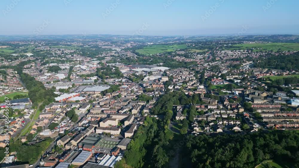 Heckmondwike, UK, captured by a drone, featuring industrial buildings, vibrant streets, the old town center, and the scenic Yorkshire view on a summer evening. Heckmondwike, UK, captured by a drone, featuring industrial buildings, vibrant streets, the old town center, and the scenic Yorkshire view on a summer evening.