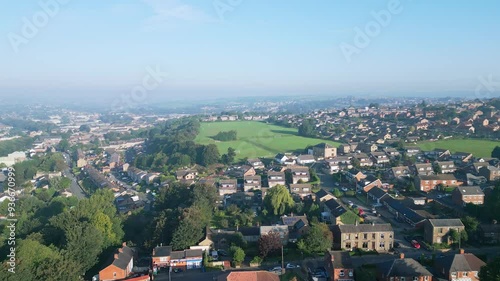 Heckmondwike, UK, captured by a drone, featuring industrial buildings, vibrant streets, the old town center, and the scenic Yorkshire view on a summer evening. photo