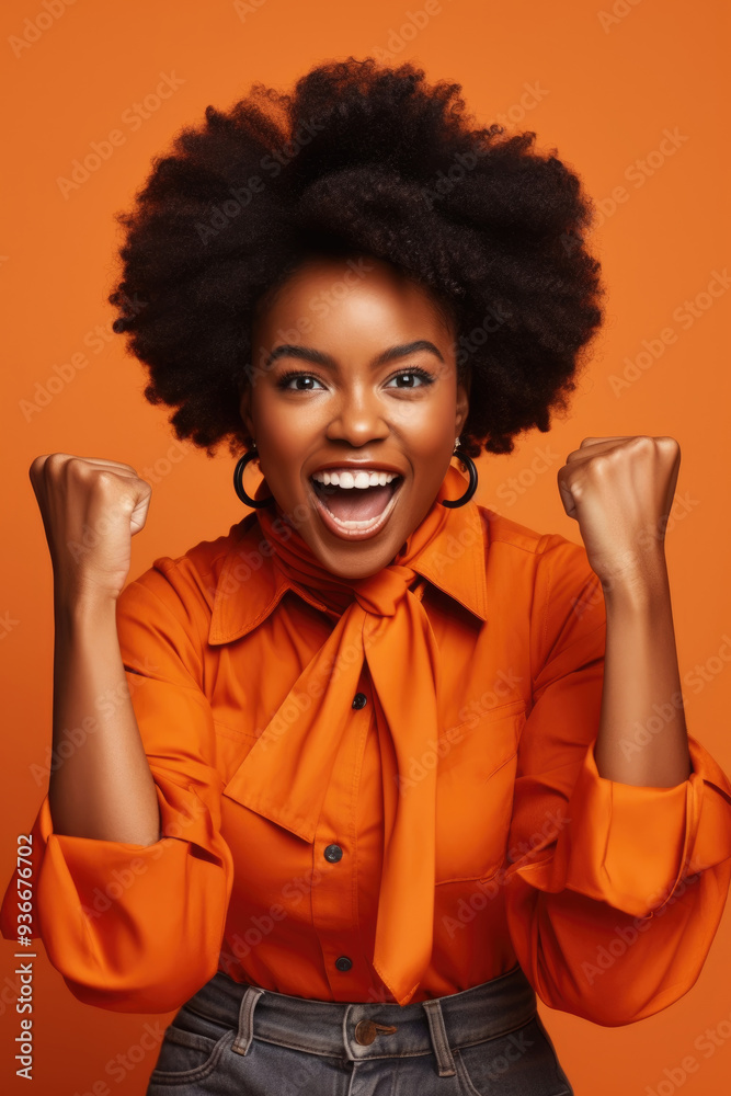 A joyful woman with an expressive face passionately celebrates an achievement, dressed in a bright orange blouse A joyful woman with an expressive face passionately celebrates an achievement, dressed in a bright orange blouse
