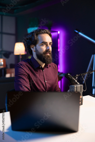 Tech expert filming technology review of newly released V mount battery, analyzing it before endorsing it to audience. Media star showing charging device to his subscribers photo