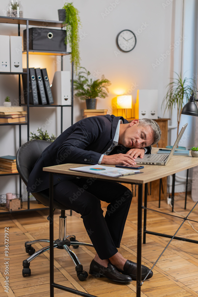 Bored sleepy businessman working on laptop computer leaning on hand sleeps at home office desk. Tired exhausted Caucasian man freelancer workaholic guy falling asleep. Employment, occupation, workless Bored sleepy businessman working on laptop computer leaning on hand sleeps at home office desk. Tired exhausted Caucasian man freelancer workaholic guy falling asleep. Employment, occupation, workless
