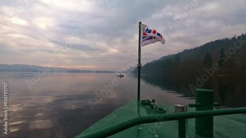 Flag flying on the Lake Windermere Cruise Ship on a foggy, misty morning.