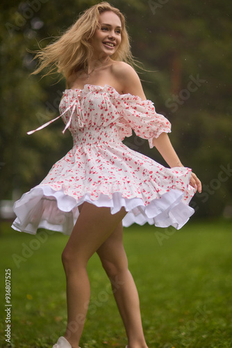 A Beautiful and Elegant Young Woman in a Lovely Summer Dress Posing Gracefully Outdoors