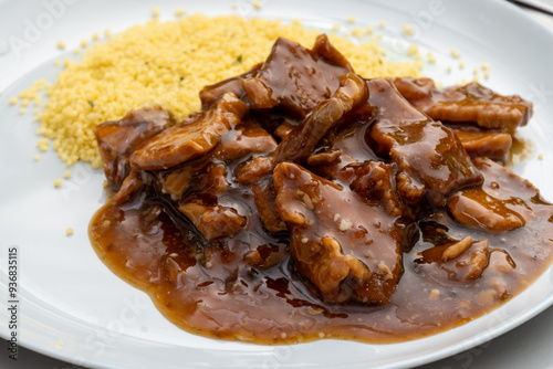 Meat dish Caramel pork served with couscous photo