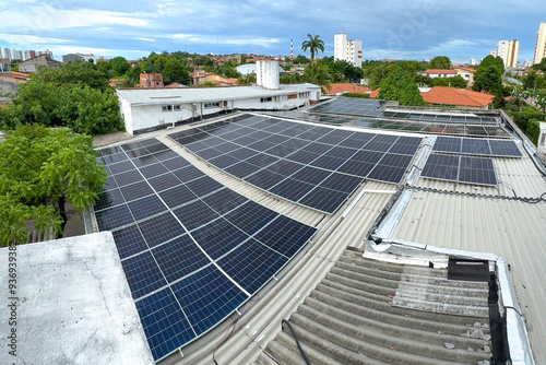 RENEWABLE SOLAR PANELS FOR ECOLOGICAL ENERGY ON A ROOF WITH AN URBAN LANDSCAPE.
