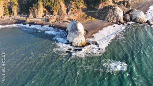 Large rocks natural monument Piedra de Iglecias Church stone on Chilean coast in Constitucion in sunset. photo