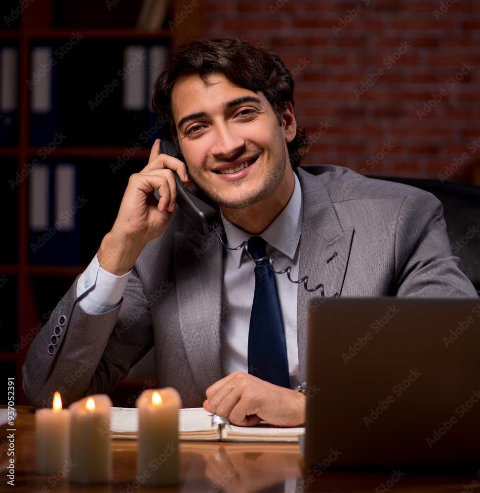 Businessman working late in office with candle light Businessman working late in office with candle light