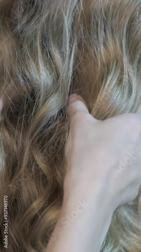 Vertical slow motion video of human hair from back side. Concept of hair care, cure, treatment, coloring, dyeing and extension.