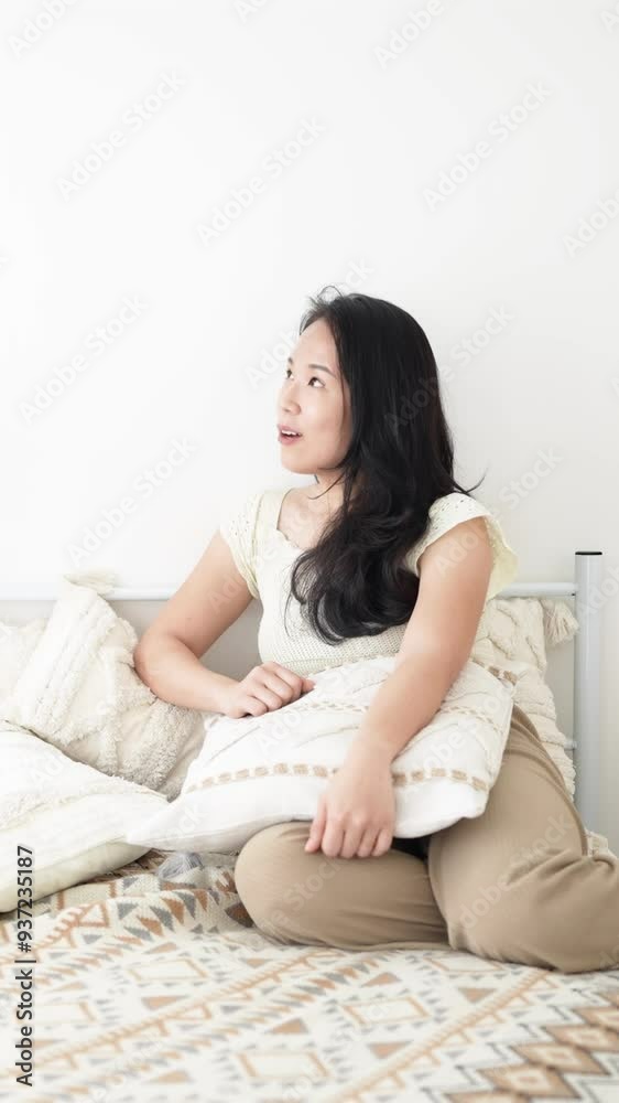 June in Selangor Malaysia Chinese Malaysian woman in her twenties and man in his thirties talking together on bed in room with stylish Western style furniture captured in slow motion vertical video June in Selangor Malaysia Chinese Malaysian woman in her twenties and man in his thirties talking together on bed in room with stylish Western style furniture captured in slow motion vertical video