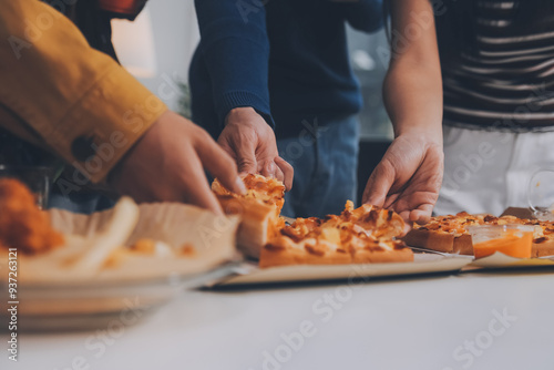 Group of young friends eating pizza.Home party.
