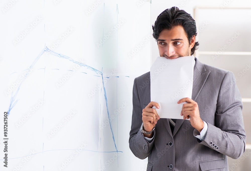 Young handsome businessman in front of whiteboard Young handsome businessman in front of whiteboard