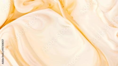 Swirling cream and caramel mixture creating a delightful marbled effect in a bowl