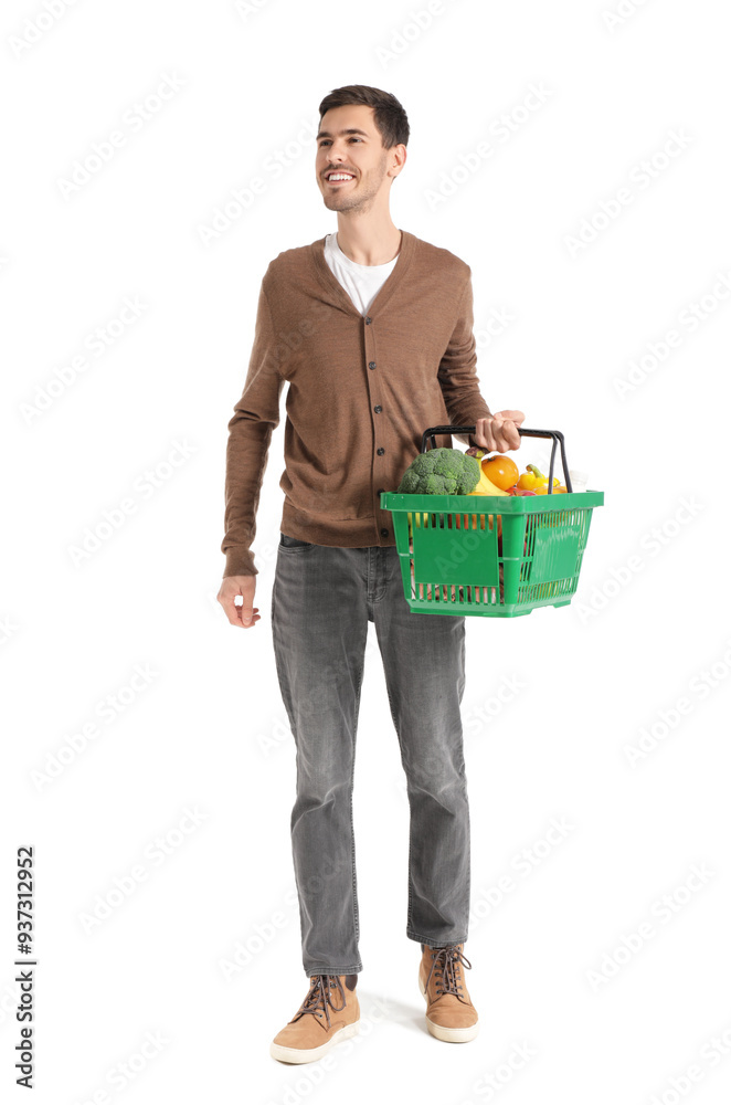 Young man with full shopping basket walking on white background Young man with full shopping basket walking on white background