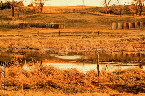 Haybales on a Hillside Overlooking a Lake photo