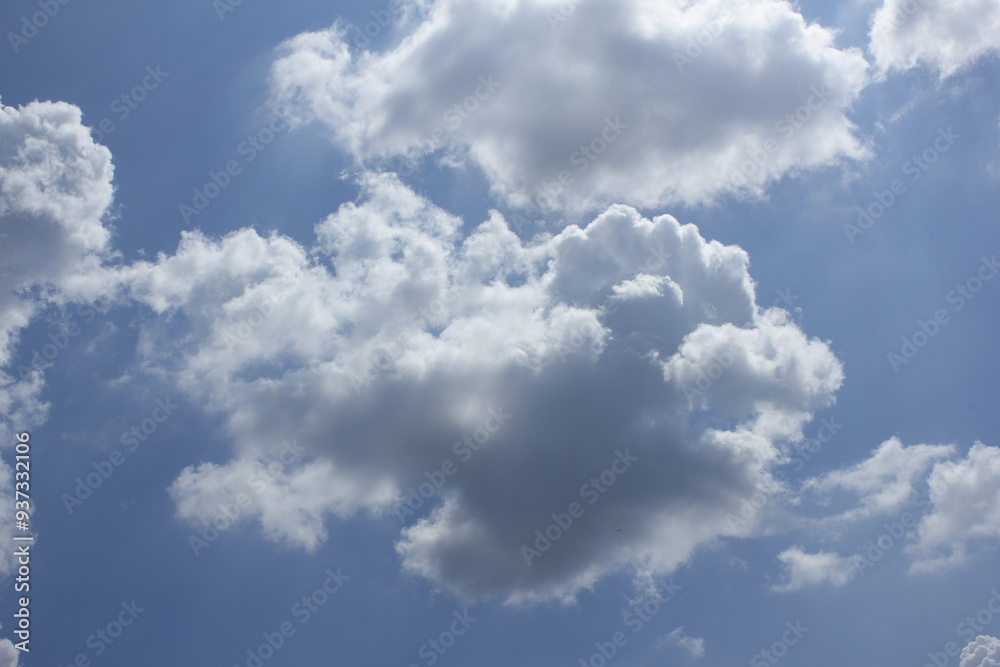 A blue sky with puffy clouds. A blue sky with puffy clouds.