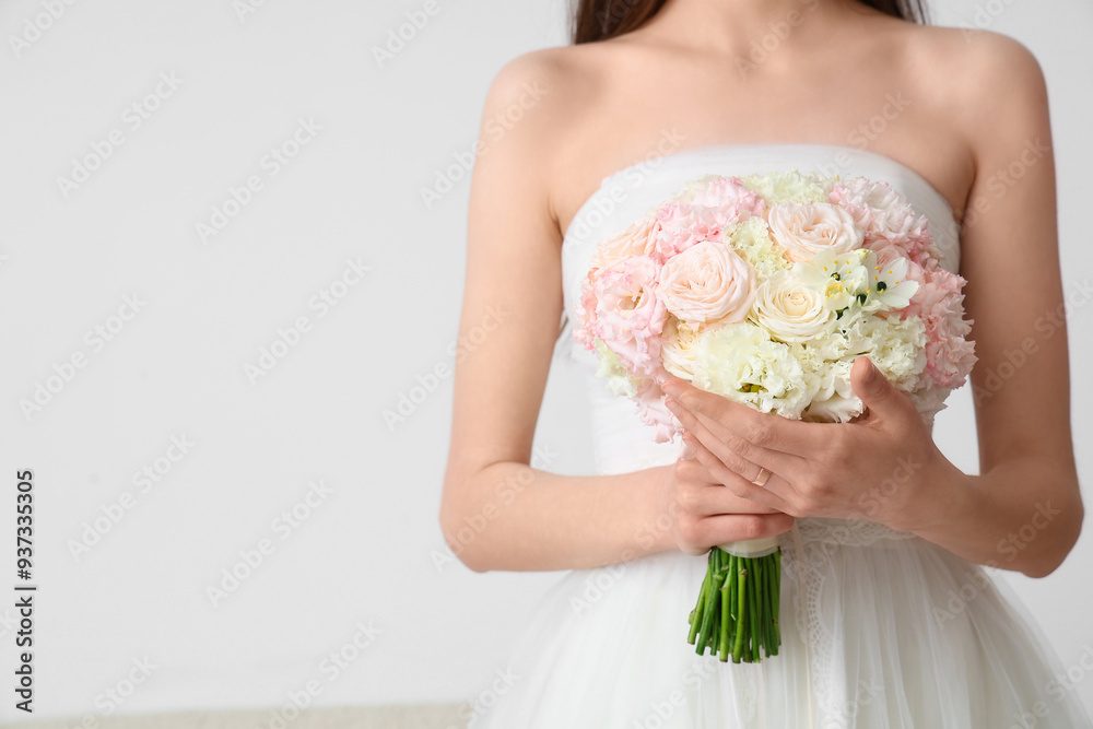 Beautiful bride with wedding bouquet on light background Beautiful bride with wedding bouquet on light background